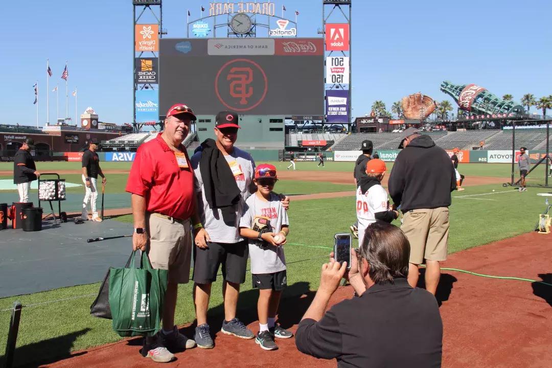 Visitors have their photo taken on the field at Oracle Park.